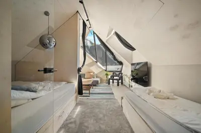 a large room with two beds and a staircase at Bryggen Penthouse I NEW 2021 in Bergen