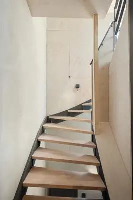 a staircase in a house with wooden steps at Bryggen Penthouse I NEW 2021 in Bergen