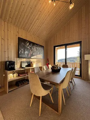 a dining room with a wooden table and chairs at Holiday Cabin with Hot Tub and Billiard Table in Tyndrom
