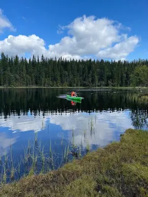 a person in a boat on a lake at Holiday Cabin with Hot Tub and Billiard Table in Tyndrom