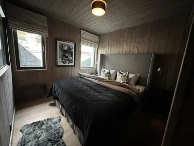 a bedroom with a bed with pillows and a rug at Hafjell Front 220B 8pers Ski InOut, Downhill bike in Hunder