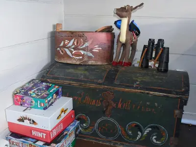 a stack of books on top of an old trunk at 6 person holiday home in Fjørtoft in Fjørtoft