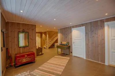 a room with wooden walls and a hallway with a door at Luxury And Comfort With Stunning Views in Beitostøl