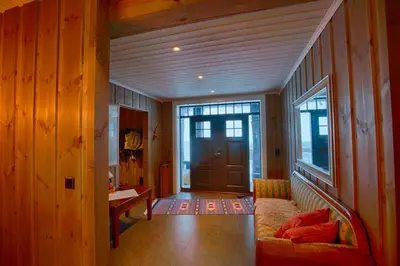 a living room with a couch and a door at Luxury And Comfort With Stunning Views in Beitostøl