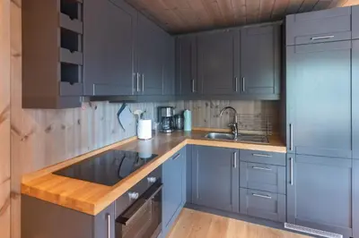 a kitchen with blue cabinets and a sink at Trysiltunet 6A in Trysil