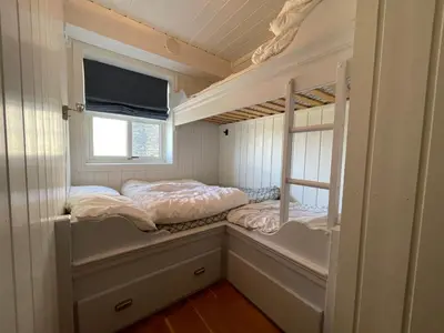 a small room with two bunk beds in it at Family-Friendly Retreat With Fireplace And Balcony in Beitostøl
