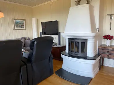 a living room with a fireplace and a couch at Family-Friendly Retreat With Fireplace And Balcony in Beitostøl