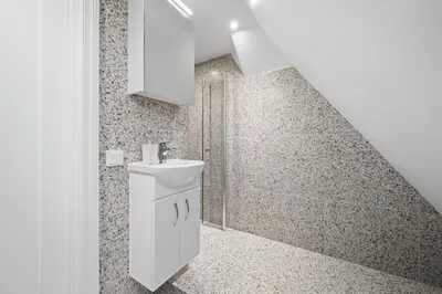 a bathroom with a sink and a staircase at Marken Townhouse NEW 2025 in Bergen