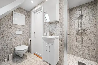 a bathroom with a toilet and a sink and a shower at Marken Townhouse NEW 2025 in Bergen