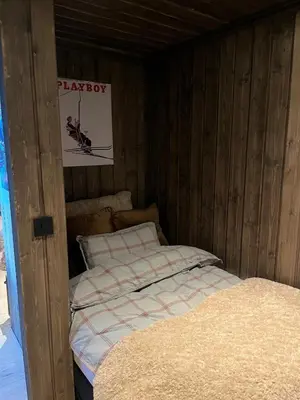 two beds in a wooden room with a play box at UNIQUE, Central Apartment at Geilo in Hol
