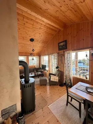 a living room with a woodburning stove in a cabin at Cabin at Furutangen - 3 bedroom family cabin in Åmot