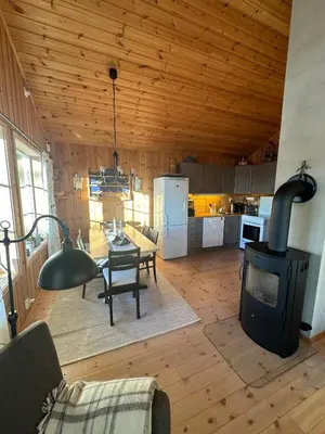 a living room with a woodburning stove in a kitchen at Cabin at Furutangen - 3 bedroom family cabin in Åmot