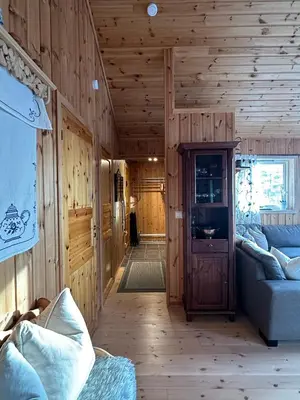 a living room with wooden walls and a wooden floor at Cabin at Furutangen - 3 bedroom family cabin in Åmot