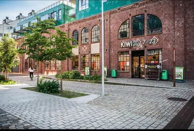a brick building with a woman walking in front of it at Central 2 story modern apartment in Bergen