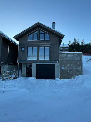 a house with a garage in the snow at Kvitfjell Year-round destination-Ski in ski out - World Cup side in Strande