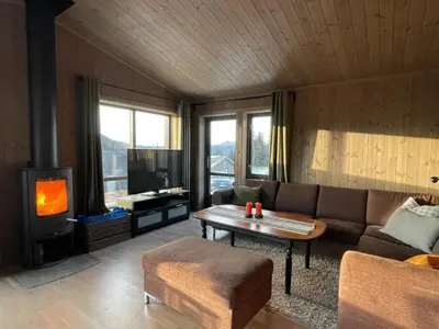 a living room with a couch and a tv at Hjertebo by Norgesbooking - cabin at Spåtind in Nord Torpa