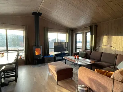 a living room with a couch and a table at Hjertebo by Norgesbooking - cabin at Spåtind in Nord Torpa