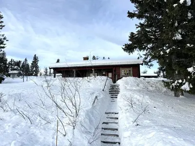 a house with stairs in the snow in front at Trysilfjellet Nord 509 in Trysil