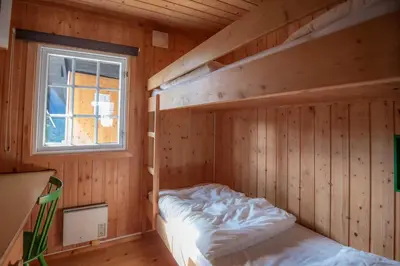 a bedroom with two bunk beds in a wooden room at Trysilfjellet Nord 637 in Trysil