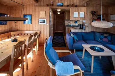 a living room with a blue couch and a table at Trysilfjellet Nord 637 in Trysil