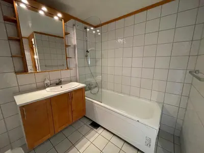 a bathroom with a sink and a tub and a mirror at Comfort, Sauna & Great Location! in Beitostøl