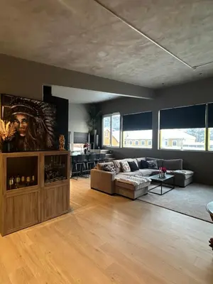a living room with a couch and a table at Ny leilighet med eget treningsstudio under ski-vm i Trondheim in Fannrem