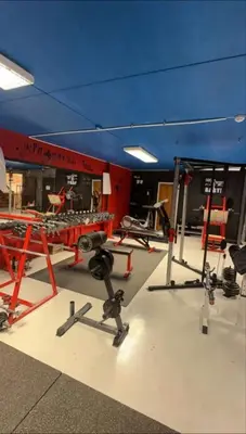 a gym with a blue ceiling and some equipment at Ny leilighet med eget treningsstudio under ski-vm i Trondheim in Fannrem