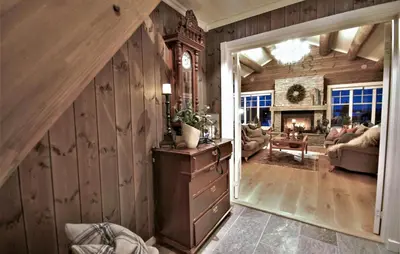 a living room with wood paneled walls and a staircase at Amazing Home In Gålå With Sauna in Gålå
