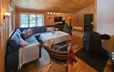 a living room with a blue couch and a table at Amazing Home In Rauland in Rauland