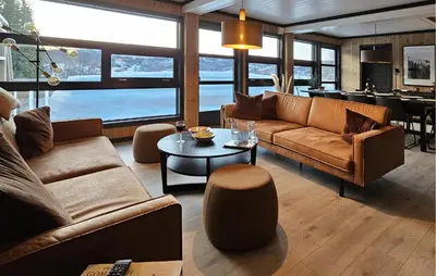 a living room with a couch and a table at 3 Bedroom Awesome Apartment In Rjukan in Rjukan