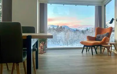 a room with chairs and a large window with a view at Awesome Home In Oppdal With Sauna in Oppdal