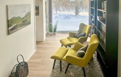 a living room with two yellow chairs and a window at Awesome Home In Oppdal With Sauna in Oppdal