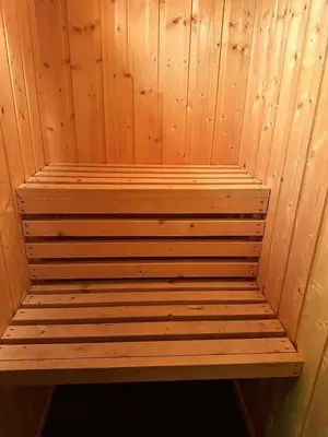 a wooden bench sitting inside of a sauna at Convenient ski in-out on Norefjell in the alpine village in Surteberg
