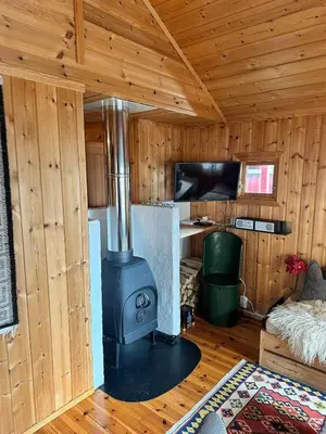 a woodburning stove in a room in a cabin at Convenient ski in-out on Norefjell in the alpine village in Surteberg