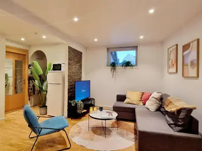 a living room with a couch and a table at City center retreat with king bed in Bergen