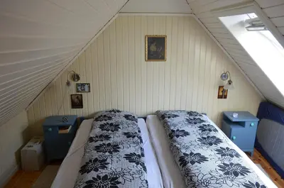 a bedroom with a bed in the attic at Historic Bergen house, right in the middle of everything! in Bergen