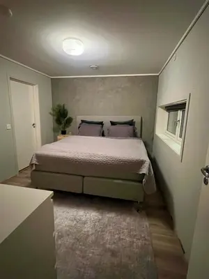 a bedroom with a large bed in a room at Moderne hjem med høy standard og privat takterasse in Trondheim