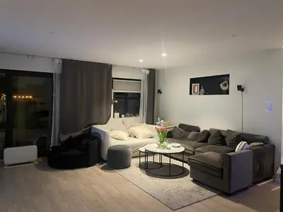 a living room with a couch and a table at Feriebolig sentralt og nærme Ski VM in Tiller