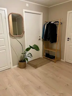 a room with a door and a mirror and a plant at Cozy and spacious apartment in Trondheim