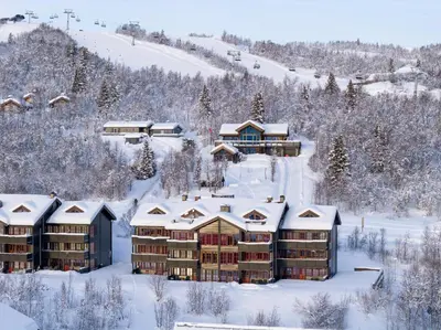 an aerial view of a resort in the snow at Spacious Retreat With Sauna And Parking in Beitostøl