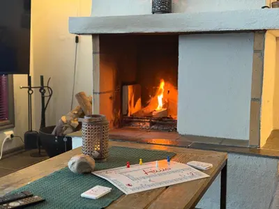 a wooden table with a fireplace in a living room at Spacious Retreat With Sauna And Parking in Beitostøl