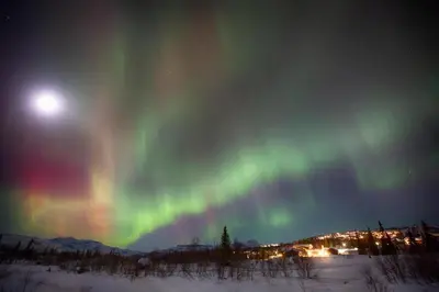 an aurora in the sky at night with the moon at Family-Friendly Stay Near Ski Trails! in Beitostøl