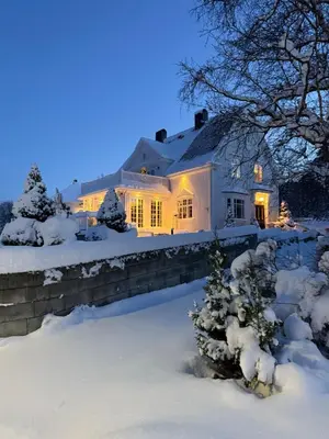 a house in the snow with lights on at Exclusive villa in Trondheim in Trondheim