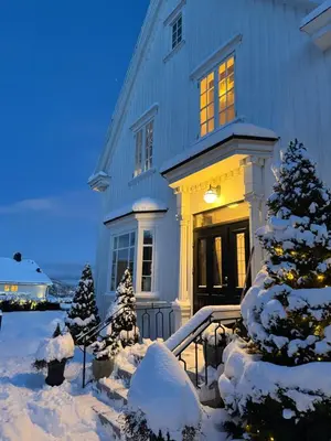 a house with snow covered trees in front of it at Exclusive villa in Trondheim in Trondheim