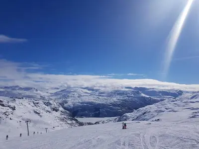 a group of people skiing down a snow covered slope at Mountain view 2 in Håra