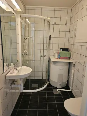 a bathroom with a shower and a toilet and a sink at Mountain view 2 in Håra