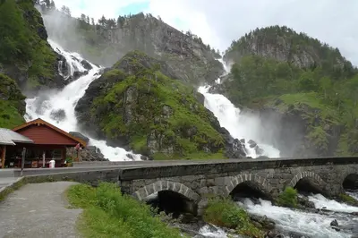 a bridge over a river with a waterfall at Mountain view 2 in Håra