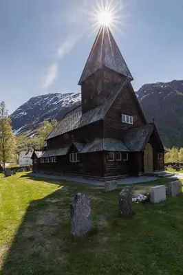 a large wooden barn with the sun shining on it at Mountain view 2 in Håra