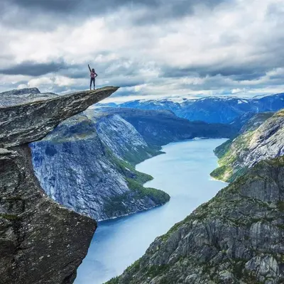 a person standing on the edge of a cliff over a river at Mountain view 2 in Håra
