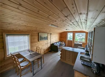 a kitchen and dining room of a log cabin at Hardangerfjord panorama 1 in Kvam